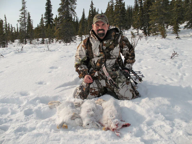 Small Game Alaska
As we pushed our way through the waist deep snow the big snowshoe hare just sat there and waited. His “white” camouflage blended perfectly with the sno